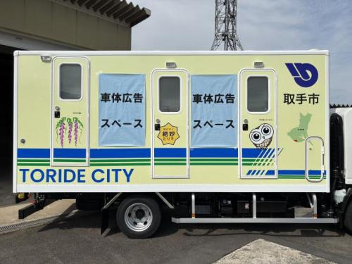 災害用トイレトラック側面に広告イメージを貼付している