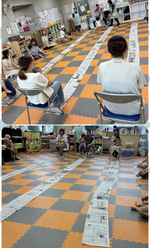 沢山の子どもたちが新聞紙にうもれている写真